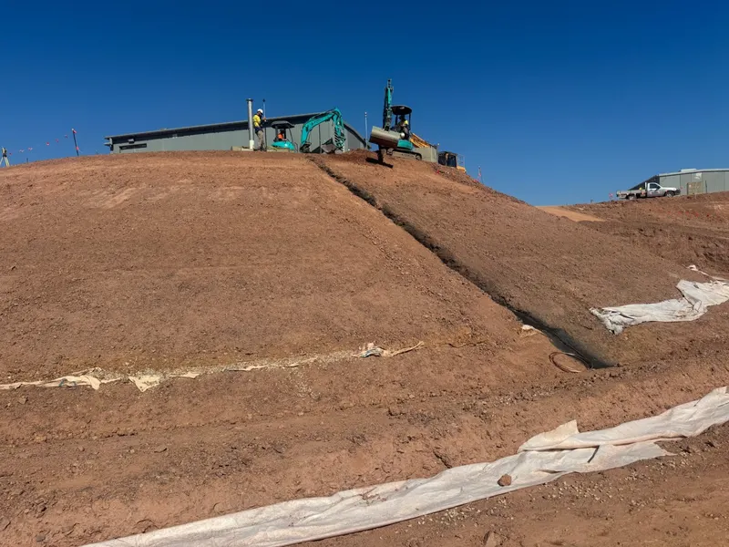 Bulk earthworks embankment with trimmed batters