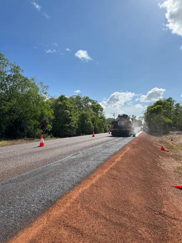 Sweeper finishing a completed spray sealed road shoulder