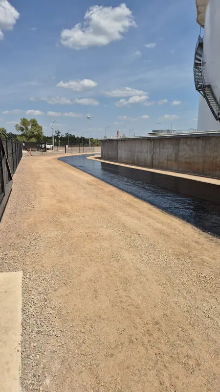 Fresh bitumen seal to perimeter access road around concrete bund