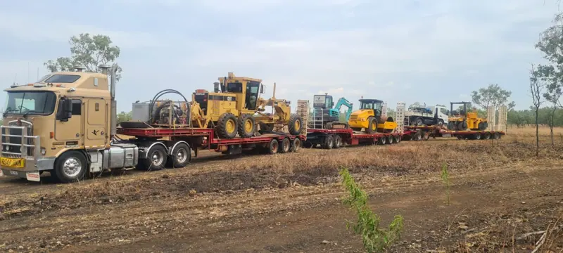 Road train convoy floating grader, excavator, roller and loader