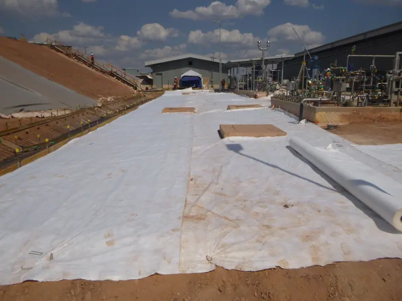 Geotextile rollout across a containment basin before concreting
