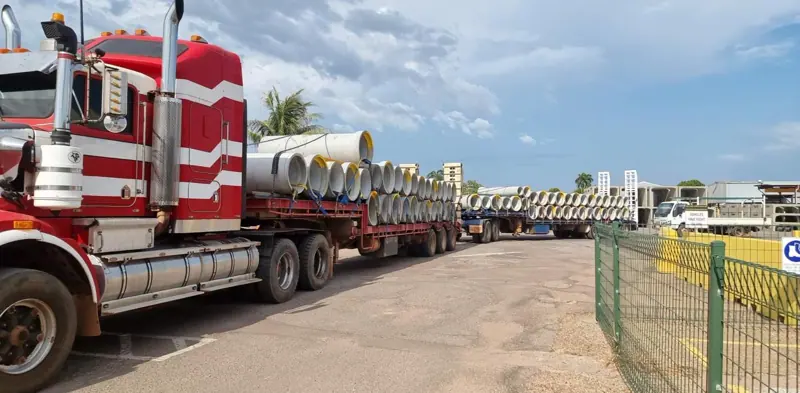 Road train hauling concrete drainage pipes