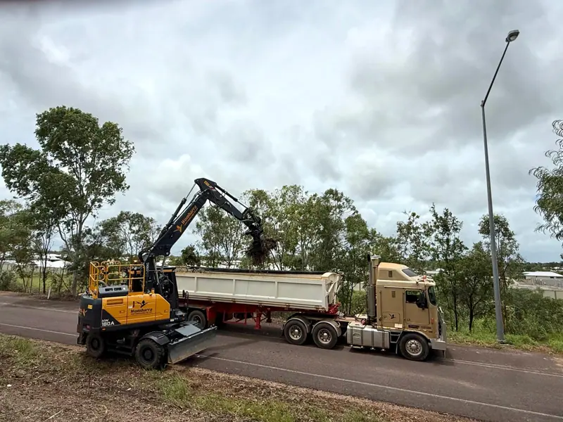 Wombarra wheeled excavator loading a tipper trailer