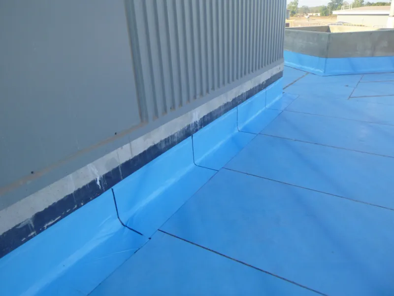 Membrane wall flashing blue roof deck