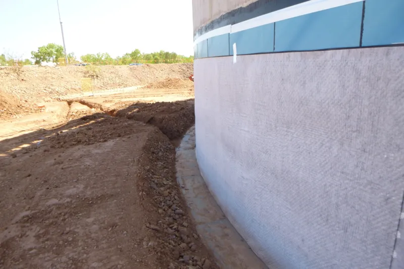 Tank base protection fabric perimeter drain