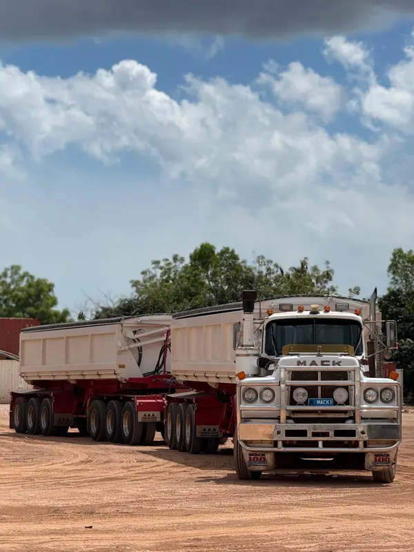 Mack side tipper road train parked on site